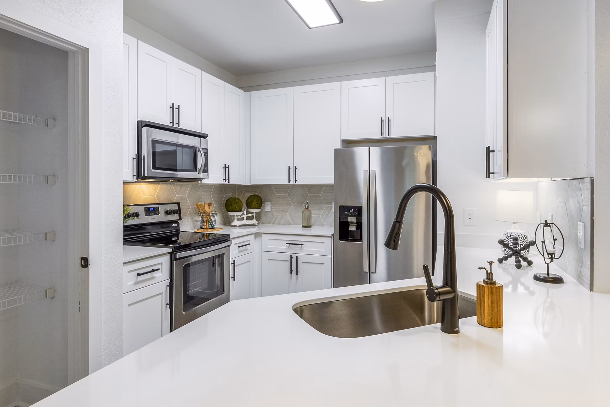 Modern kitchen with stainless steel appliances at The Avenues at Verdier Pointe Apartments