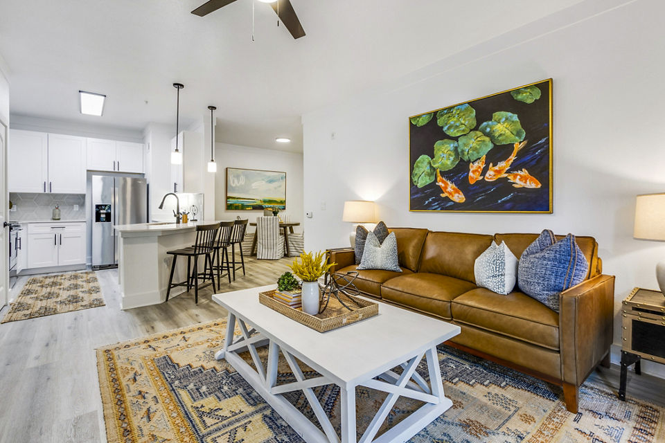 Spacious living room with modern furnishings in The Avenues at Verdier Pointe Apartments