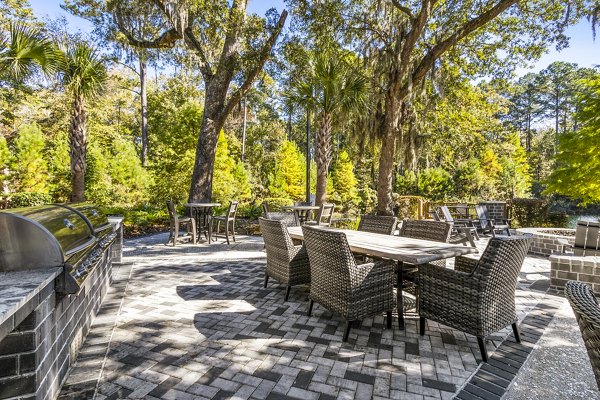 Grill area and patio with outdoor seating at The Avenues at Verdier Pointe Apartments