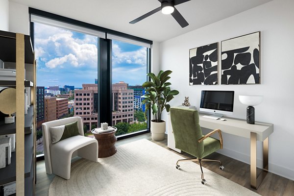 Home office with ergonomic chair and sleek desk at Nomia Apartments