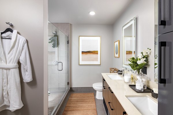 Bathroom featuring sleek fixtures and contemporary design in Nomia Apartments