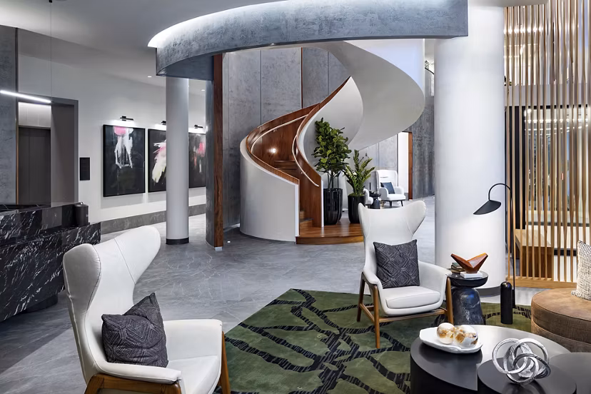 Clubhouse featuring modern lounge seating and pool tables at Nomia Apartments