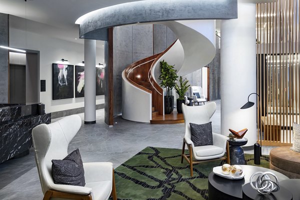 Clubhouse featuring modern lounge seating and pool tables at Nomia Apartments