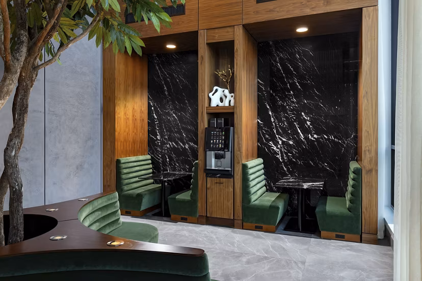 Clubhouse featuring modern seating and large windows at Nomia Apartments