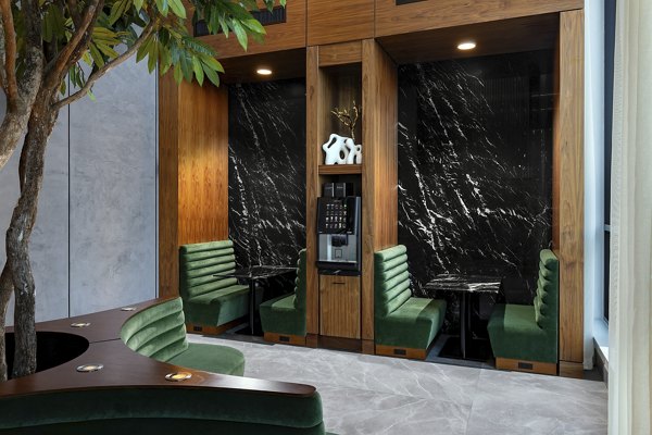 Clubhouse featuring modern seating and large windows at Nomia Apartments