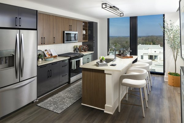 Nomia Apartments: Modern kitchen with stainless steel appliances and sleek cabinetry