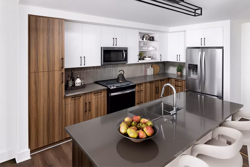 Modern kitchen with stainless steel appliances and granite countertops at Nomia Apartments luxury living space
