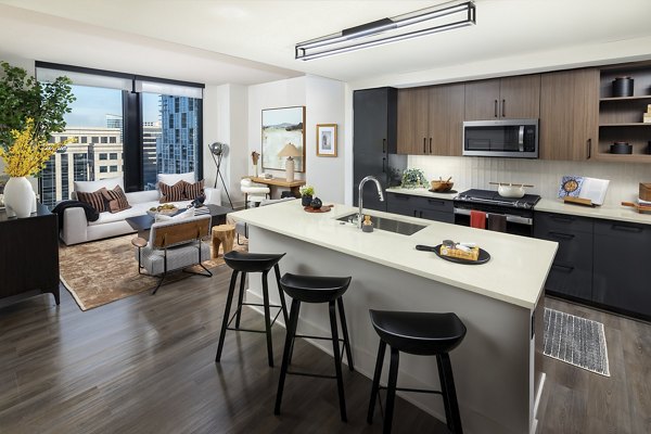 Modern kitchen with stainless steel appliances in Nomia Apartments