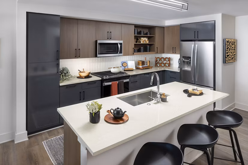 Modern kitchen with stainless steel appliances in Nomia Apartments