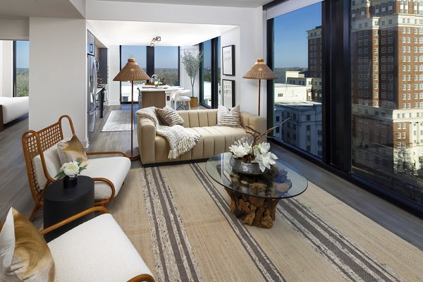 Spacious living room with modern decor at Nomia Apartments, featuring stylish furniture and ambient lighting