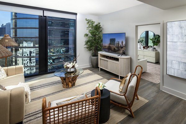 Spacious living room with modern furnishings and natural light in Nomia Apartments