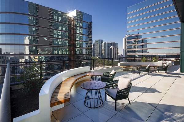 Rooftop deck with modern seating and city views at Nomia Apartments, perfect for relaxation and gatherings