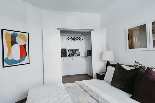 Bedroom with modern furnishings and natural light at Tanager Apartments