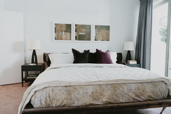 Cozy bedroom with modern design elements at Tanager Apartments: luxury living near scenic parks