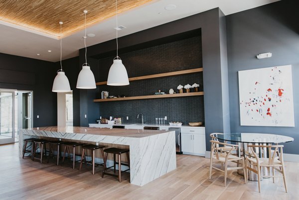 Clubhouse featuring modern decor and entertainment facilities at Tanager Apartments