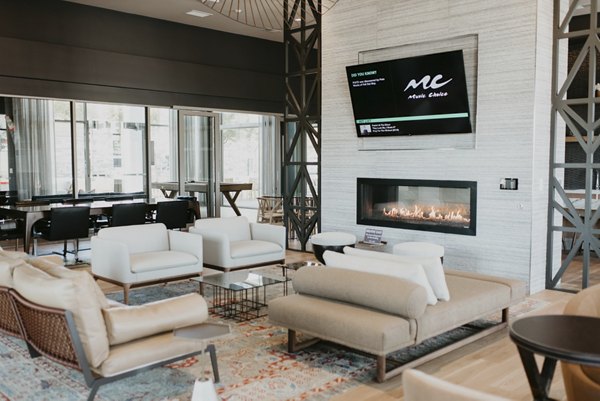 Modern clubhouse with elegant seating and large windows at Tanager Apartments, a Greystar luxury community