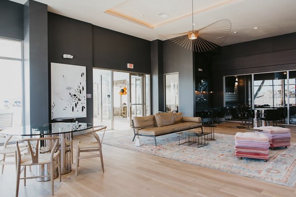 Tanager Apartments: Elegant clubhouse with cozy seating and modern decor