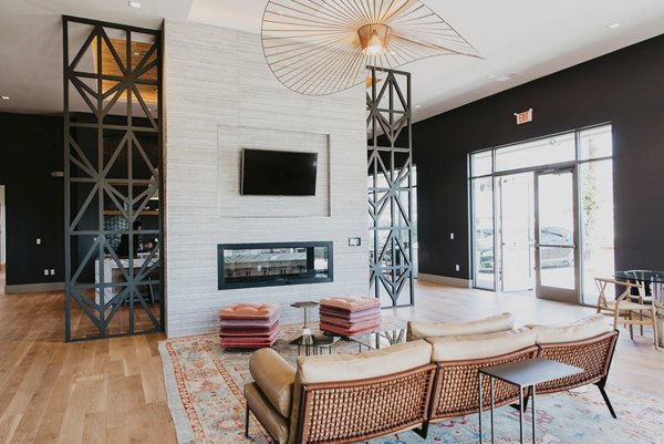 Modern clubhouse with stylish seating and entertainment area at Tanager Apartments
