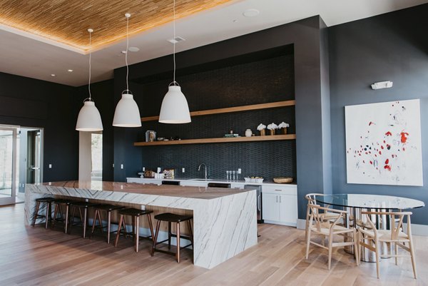 Clubhouse featuring modern decor and cozy seating at Tanager Apartments, a luxurious community by Greystar