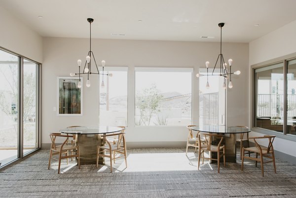 Modern clubhouse featuring cozy seating and entertainment options at Tanager Apartments, a Greystar luxury living community