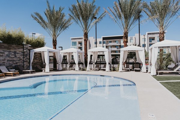 Rooftop pool with lounge chairs at Tanager Apartments, offering luxury leisure spaces in a premier location
