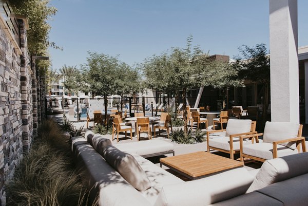 Lush courtyard with seating and greenery at Tanager Apartments, luxury living space in a serene setting