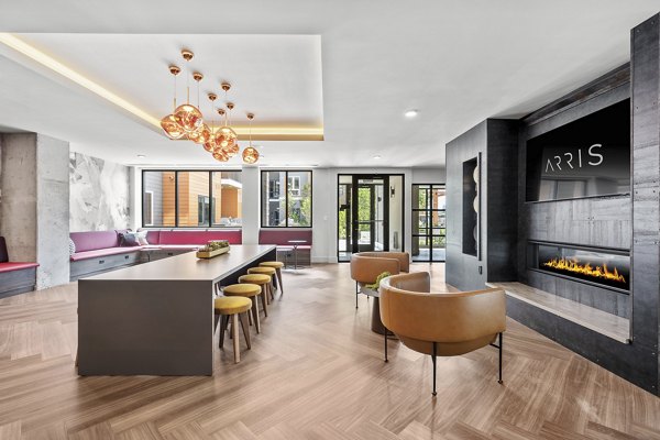 Clubhouse at Arris Apartments featuring modern design and elegant seating areas, ideal for social gatherings in a luxury setting