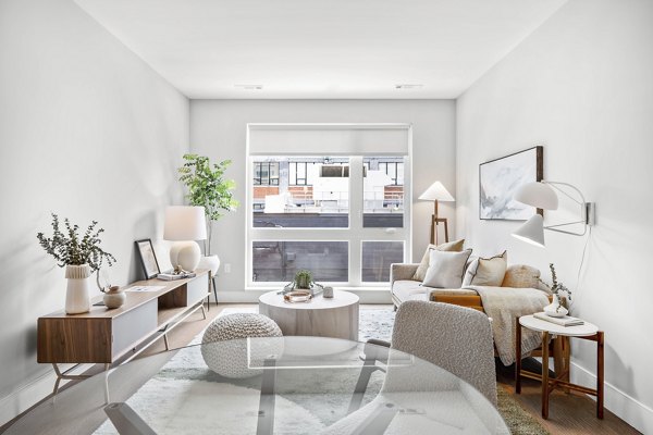 Dining area featuring modern decor and ample natural light at Arris Apartments