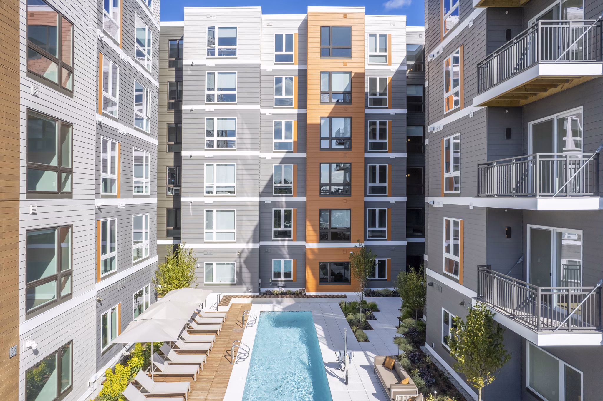 Rooftop pool with skyline views at Arris Apartments