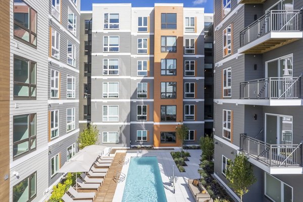 Rooftop pool with skyline views at Arris Apartments