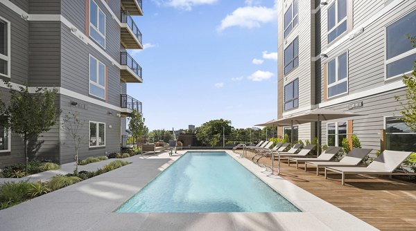 Pool with sundeck at Arris Apartments offering relaxation and leisure opportunities for residents