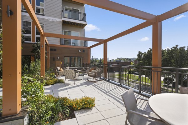 Courtyard featuring lush greenery and seating areas at Arris Apartments