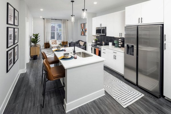 Modern kitchen with granite countertops and stainless steel appliances at Broadstone Craft Apartments