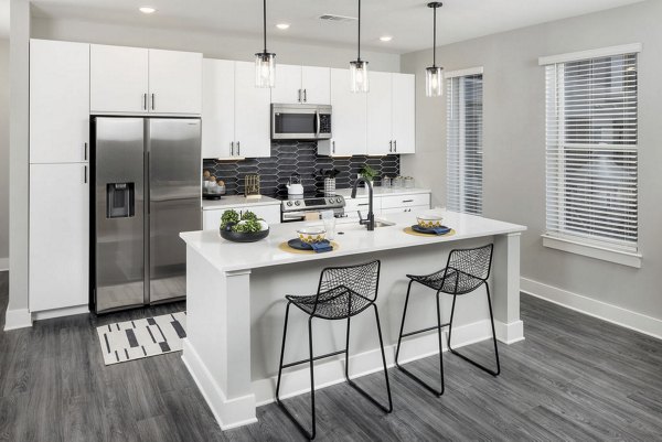 Modern kitchen with stainless steel appliances in Broadstone Craft Apartments, luxury living by Greystar