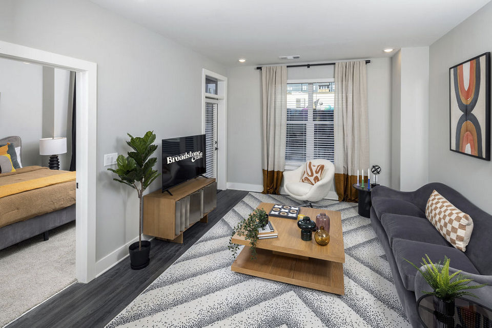 Cozy living room with modern decor in Broadstone Craft Apartments, offering luxury living with spacious layouts and premium finishes
