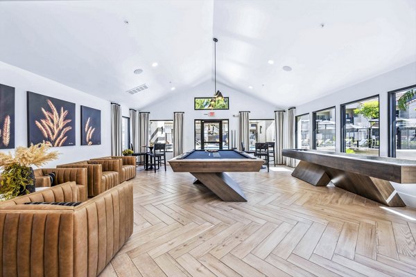 Clubhouse game room with billiard tables and lounge seating at Hideaway North Scottsdale Apartments