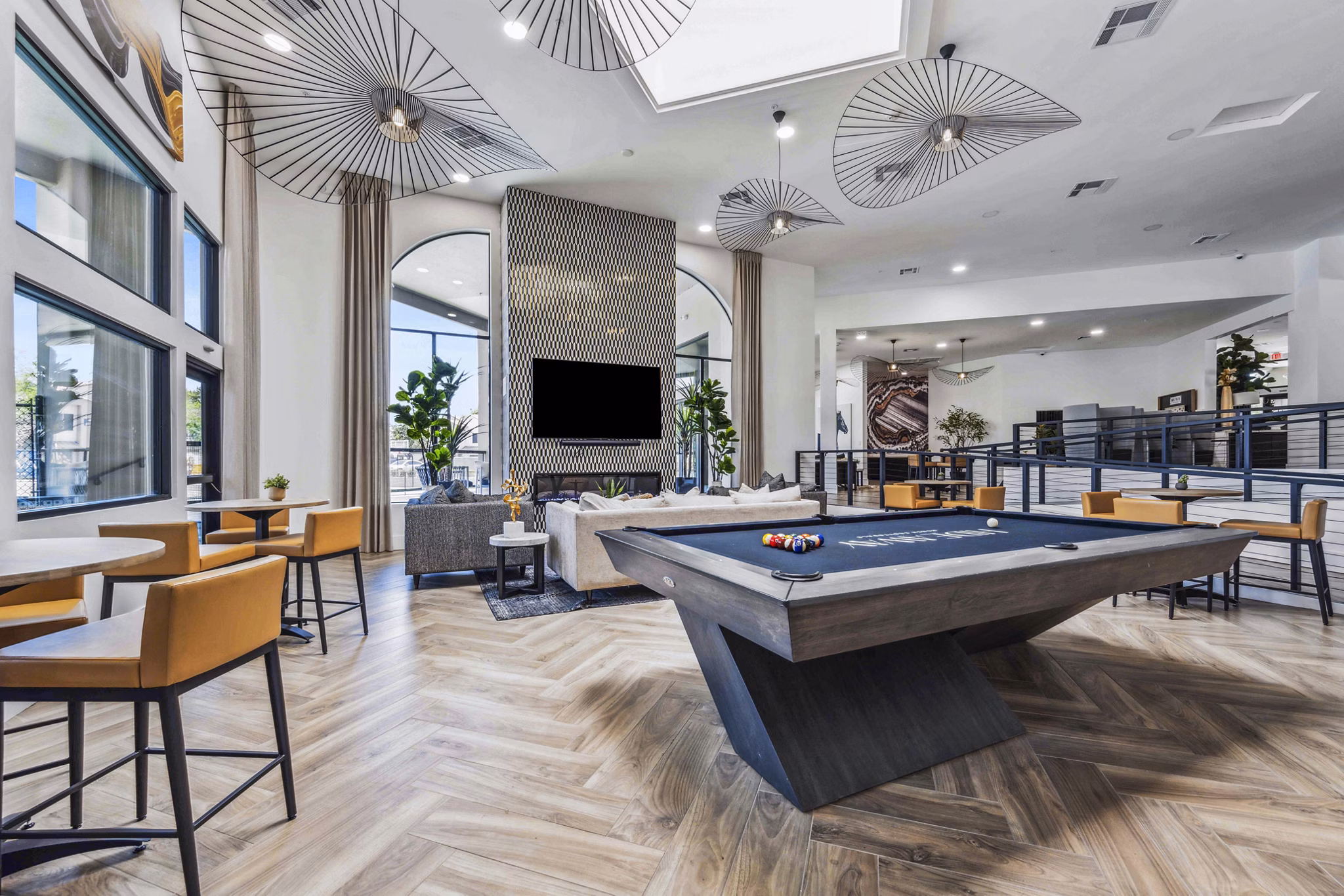 Clubhouse game room featuring pool table and lounge area at Hideaway North Scottsdale Apartments
