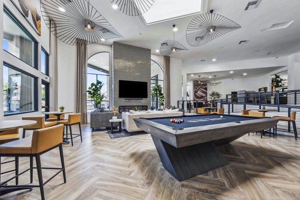 Clubhouse game room featuring pool table and lounge area at Hideaway North Scottsdale Apartments