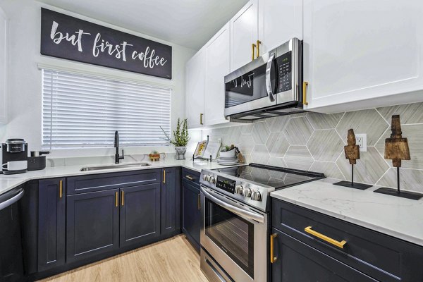 Modern kitchen with stainless steel appliances in Hideaway North Scottsdale Apartments
