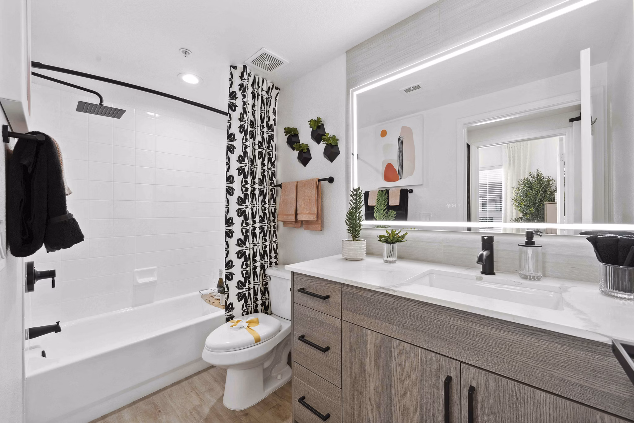 Luxurious bathroom featuring marble countertops and a glass shower at Nines at Kierland Apartments