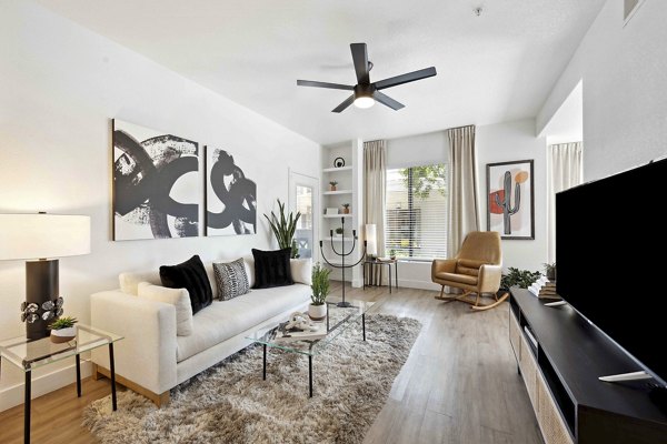 Living room with modern decor and natural light at Nines at Kierland Apartments