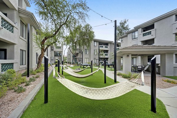 Nines at Kierland Apartments: Tranquil courtyard with lush landscaping and seating areas, offering luxury living in Scottsdale