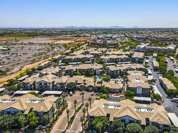 Aerial view of luxury apartments and green spaces in a vibrant residential community