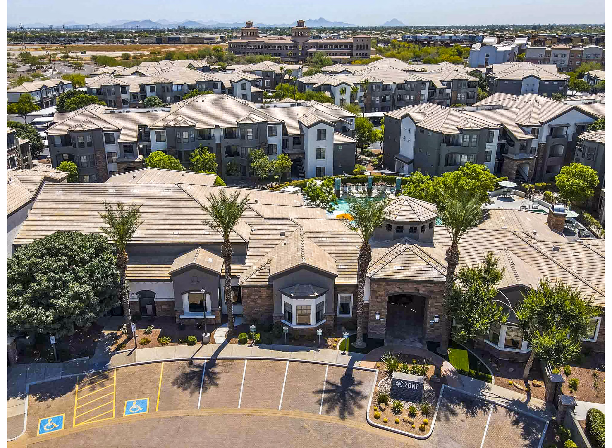 Aerial view of a luxury apartment complex featuring multiple buildings and landscaped areas
