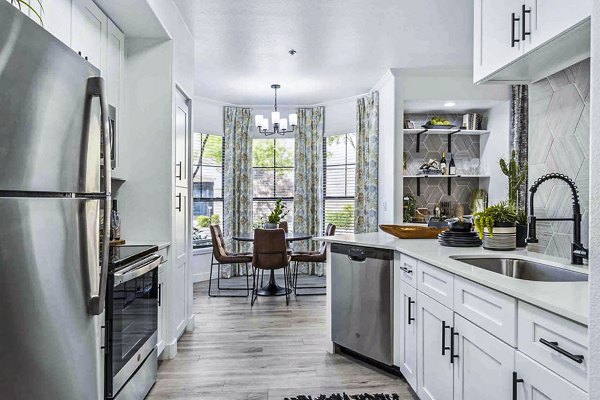 Contemporary kitchen with stainless steel appliances at Zone Apartments
