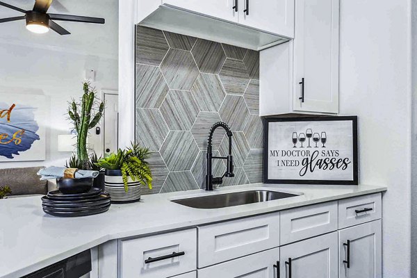 Sleek modern kitchen featuring stainless steel appliances at Zone Apartments