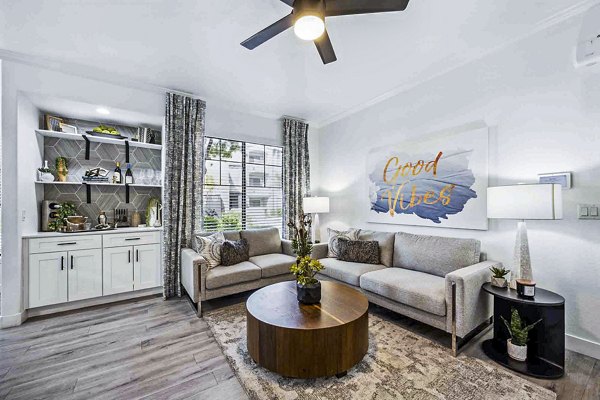 Modern living room featuring chic furniture and ample natural light at Zone Apartments