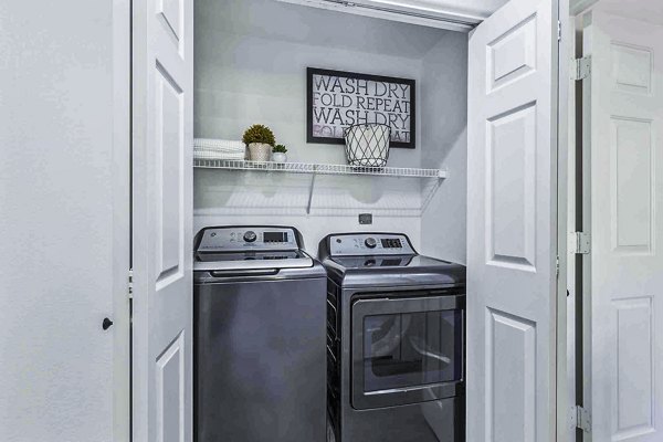 Laundry room with modern appliances in Zone Apartments