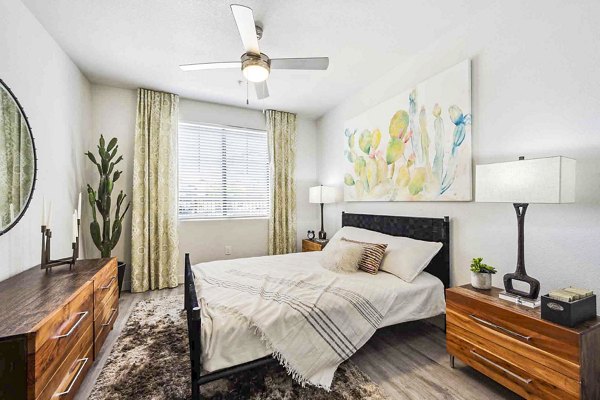 Luxurious bedroom with modern decor and large windows at Zone Luxe Apartments, offering comfort and style in a premium living environment
