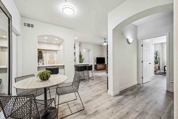 Dining room with elegant table settings at Zone Luxe Apartments, a luxury Greystar community